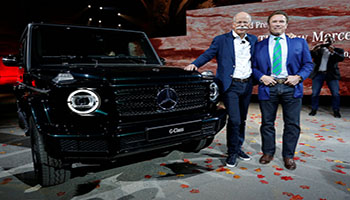 Arnold Schwarzenegger helps Daimler CEO Dieter Zetsche at a news conference to unveil new Mercedes G-Class models at the North American International Auto Show in Detroit, Michigan, U.S. January 14, 2018. REUTERS/Jonathan Ernst